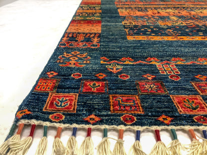 Closeup of a blue Gabbeh Khorjin rug by Kirishian Rugs showing intricate traditional patterns and rich woven textures.
