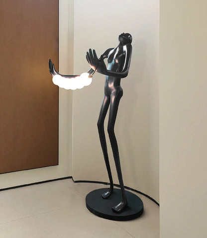 Tilt-head human sculpture floor lamp by Korewolamp featuring a modern design with a tilted head and adjustable lighting.