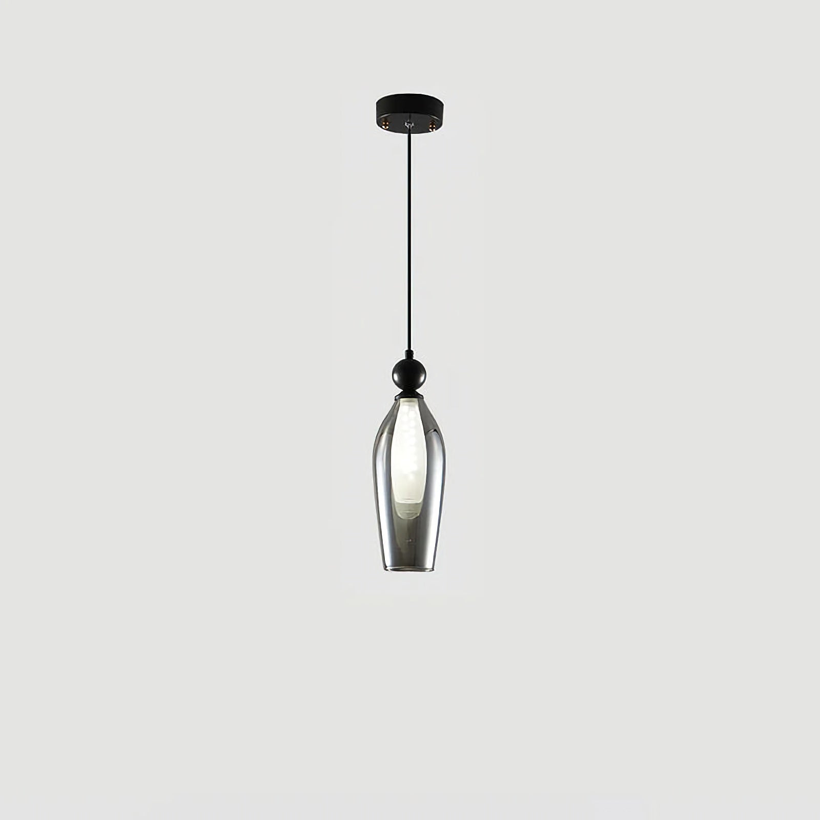 Korewolamp Vista glass pendant light with clear glass shade hanging from a black cord in modern home decor.