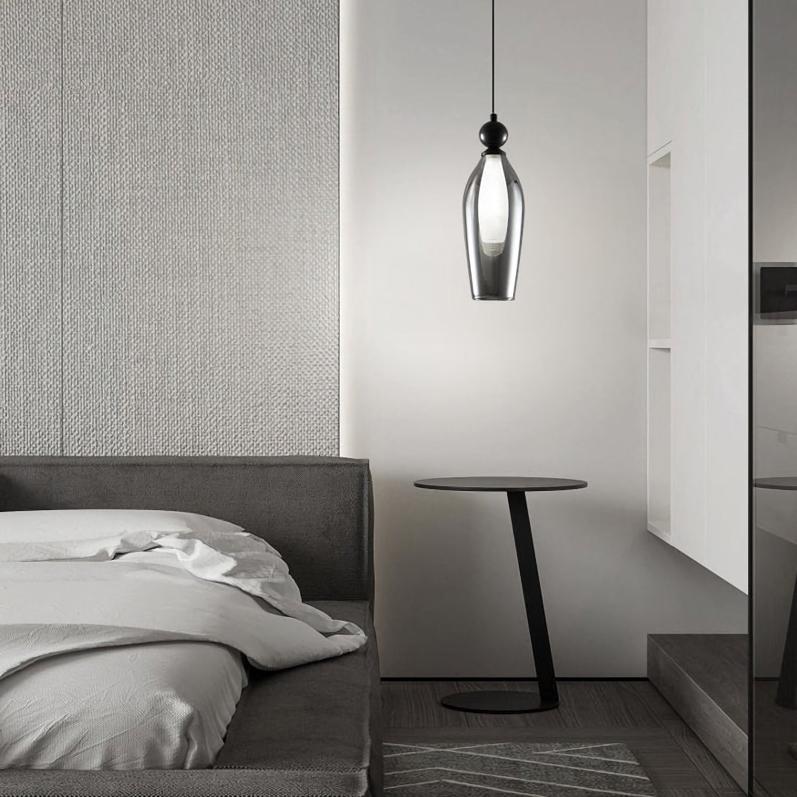 Korewolamp Vista glass pendant light hanging from the ceiling with a clear glass shade and modern design.