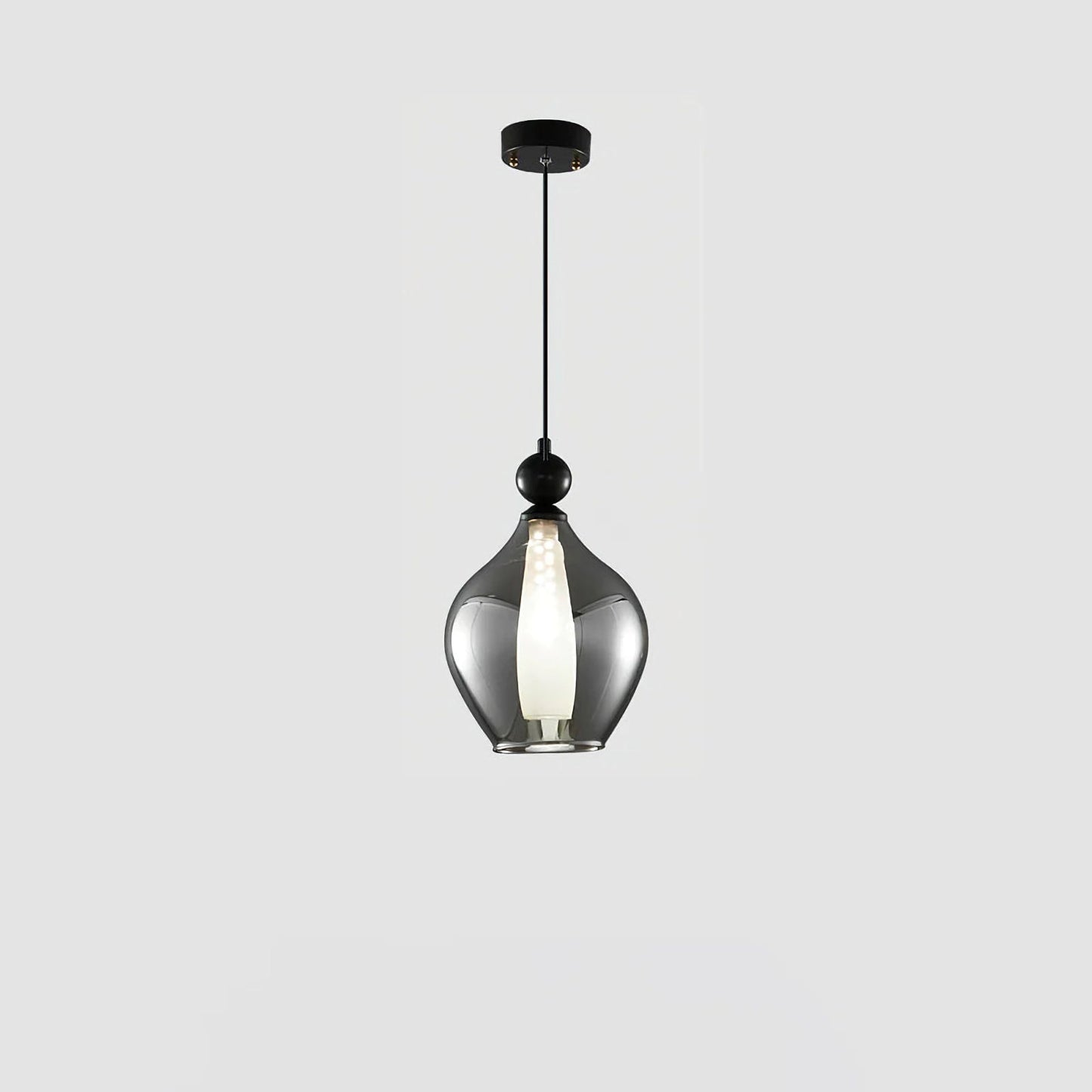Korewolamp Vista glass pendant light hanging from ceiling, clear spherical glass shade with modern design in a well-lit room