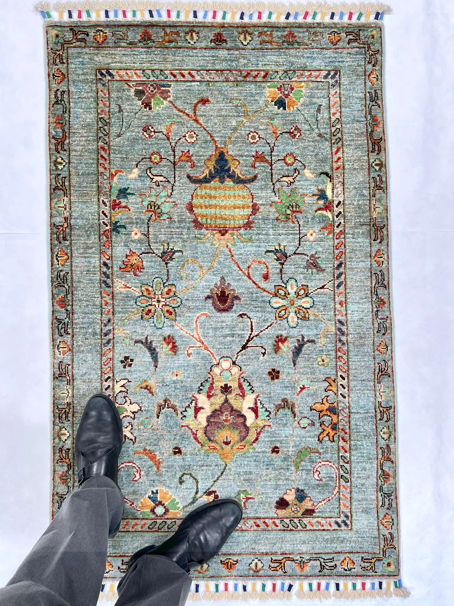 Afghan Khorjin rug by OneKind from Kirishian Rugs, light blue and multicolor, measuring 2'07" x 4'04" with intricate traditional patterns.