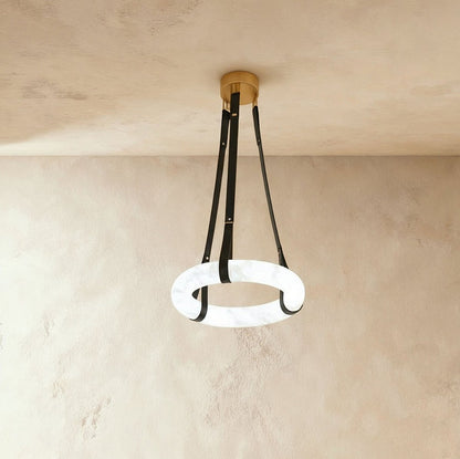 Aktis Alabaster Pendant Light by Residence Supply hanging from ceiling with warm glow and smooth alabaster shade.