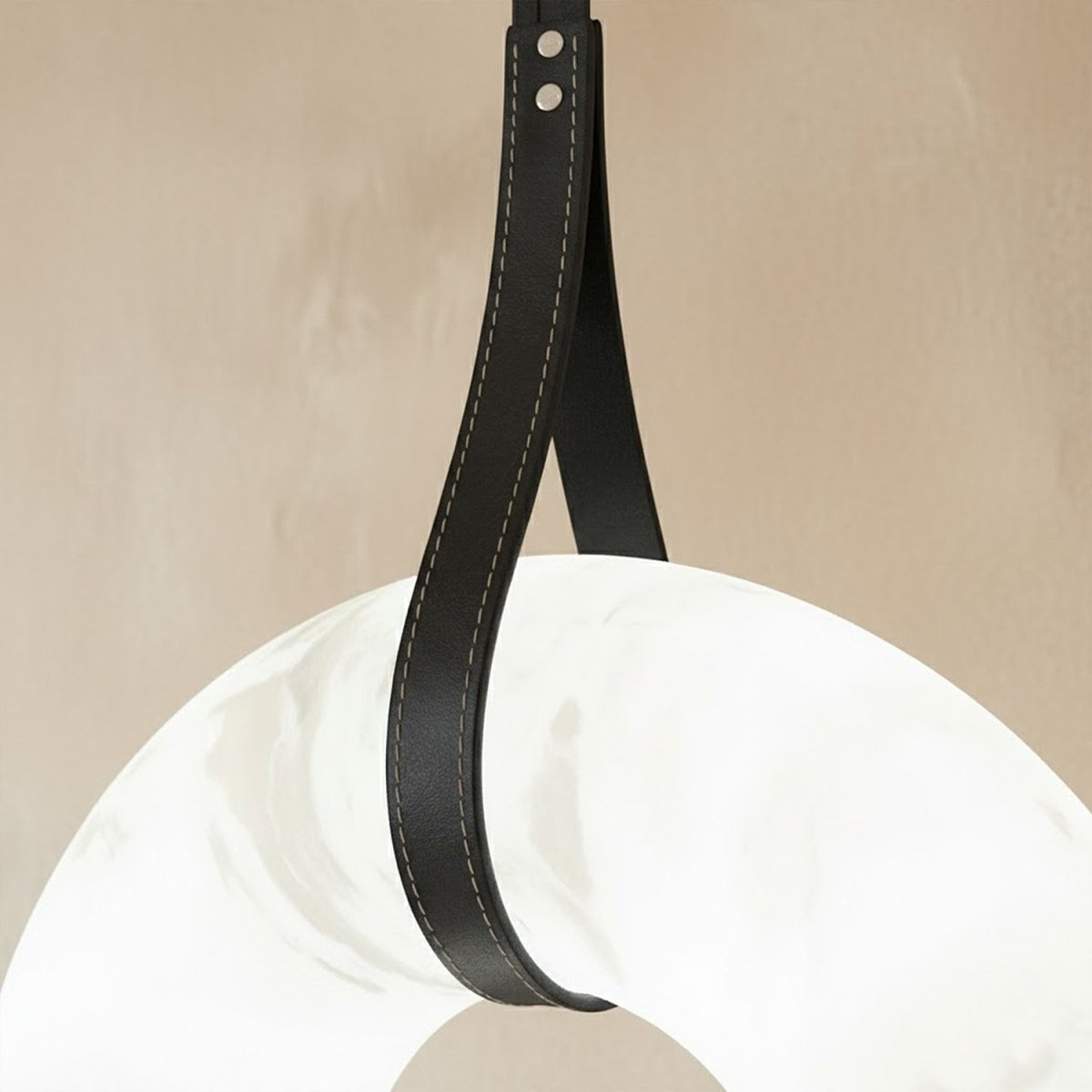 Aktis Alabaster Pendant Light by Residence Supply hanging with a warm glow and sleek modern design.