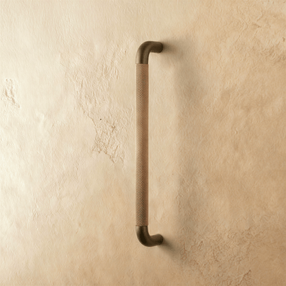 A Alyma knob and pull bar set from Residence Supply, featuring sleek metal hardware for cabinet doors and drawers.