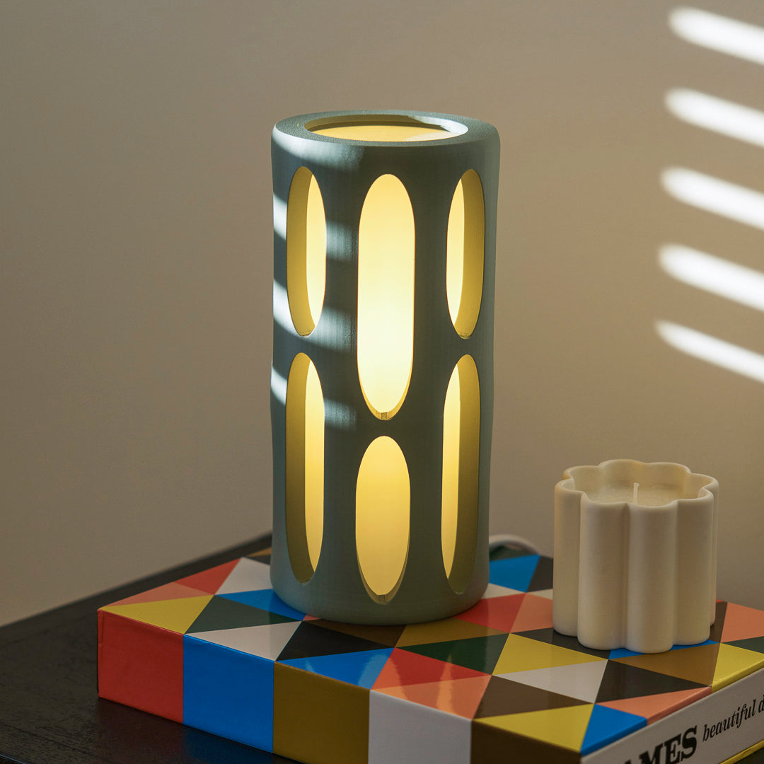 Mint-colored Terra Labs Amoeba Table Lamp with a unique organic shape and sleek design, perfect for modern home decor.