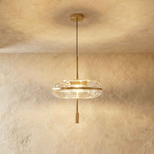 Anala Pendant Light by Residence Supply hanging from ceiling with a modern design and metal finish in a stylish interior setting.