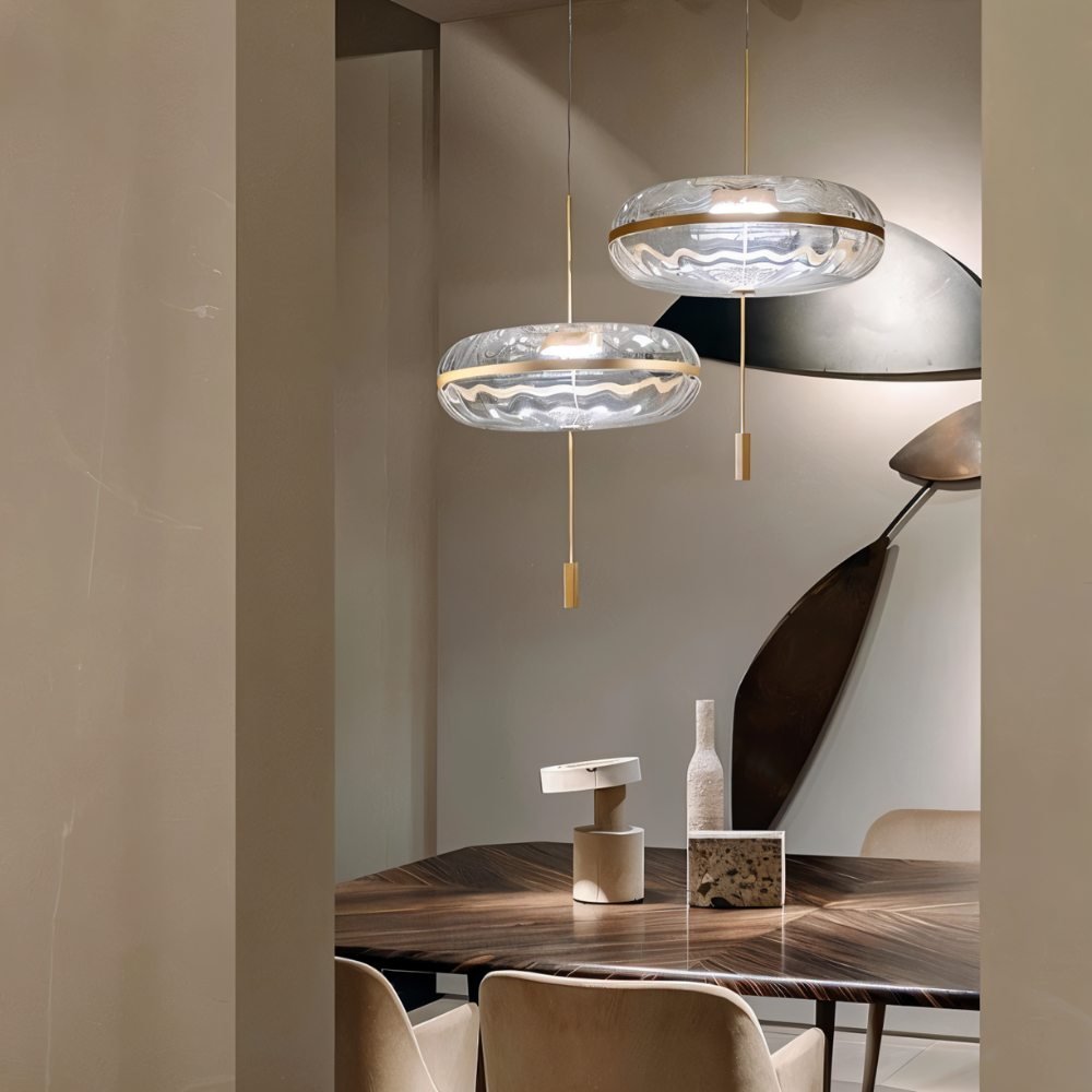 Sculptural glass Anala Pendant Light by Residence Supply hanging above a dining table with a modern design.