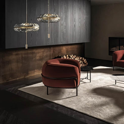 Sculptural glass Anala pendant light by Residence Supply hanging in a modern living room.