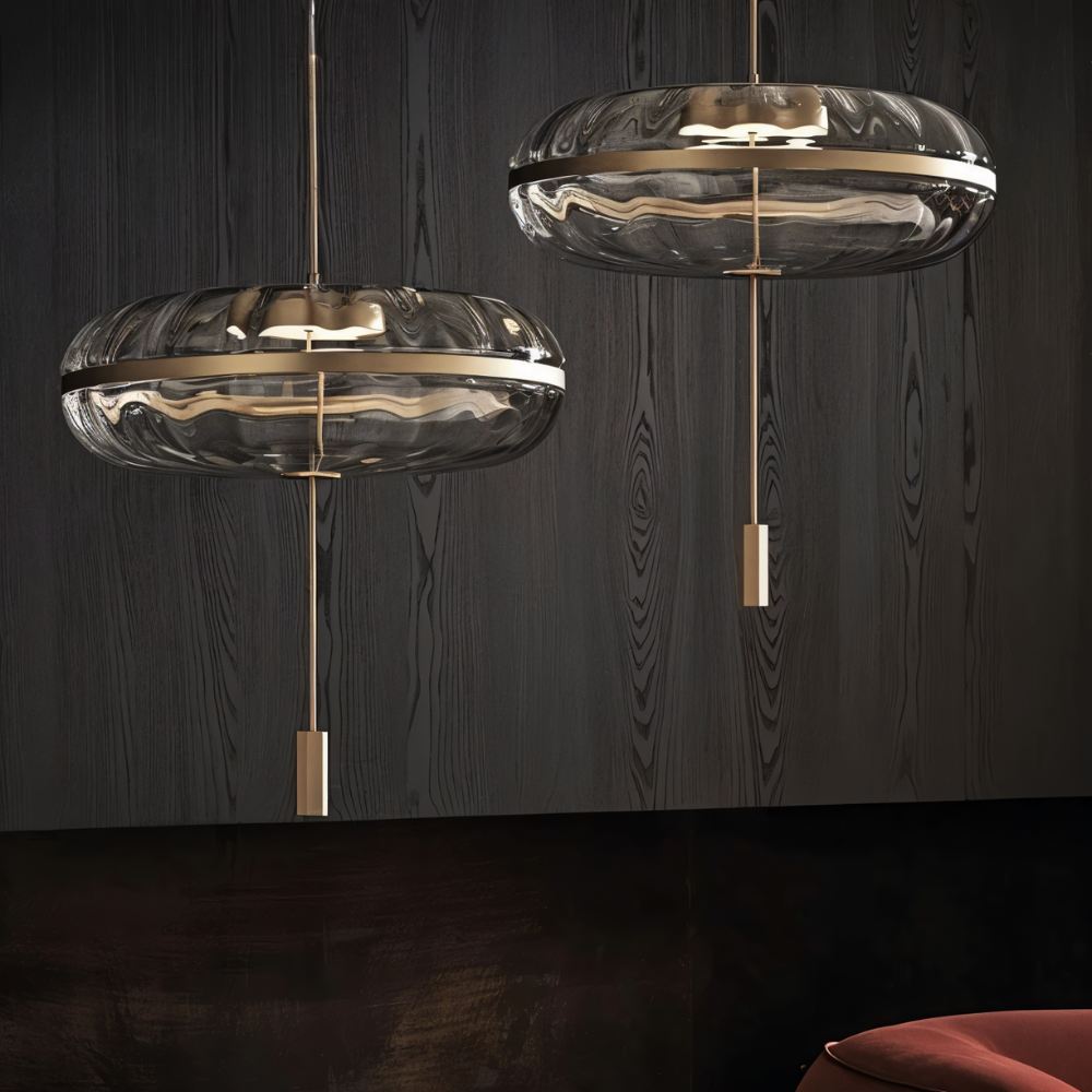 Pair of sculptural glass Anala Pendant Lights by Residence Supply hanging from a ceiling fixture.