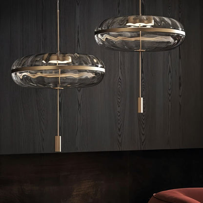 Pair of sculptural glass Anala Pendant Lights by Residence Supply hanging from a ceiling fixture.
