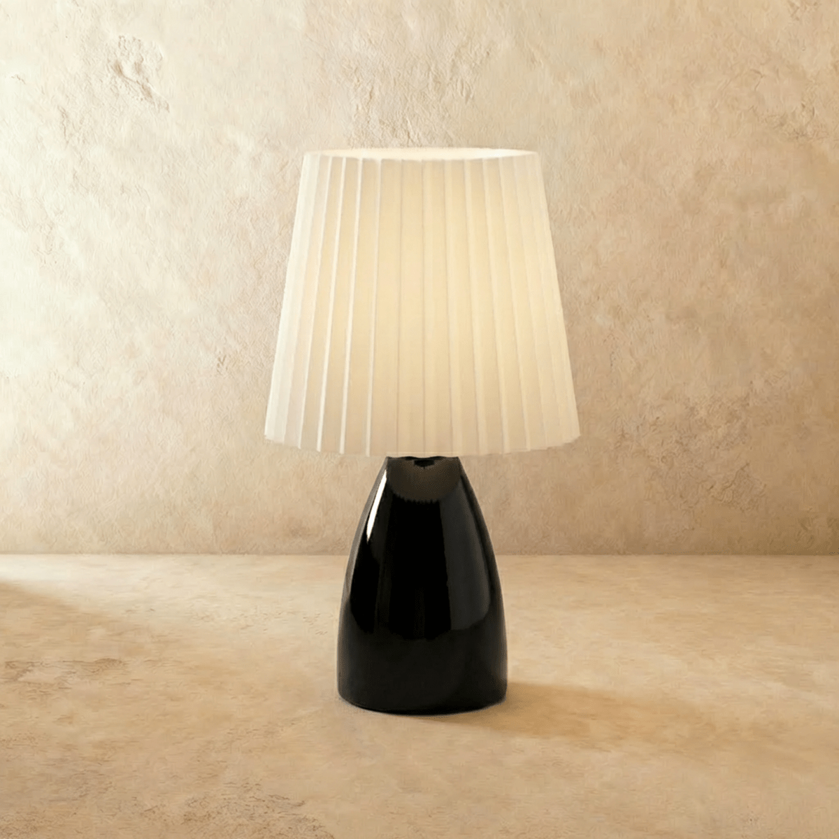 Residence Supply Apollo table lamp with a sleek modern design and neutral-colored lampshade on a wooden base.