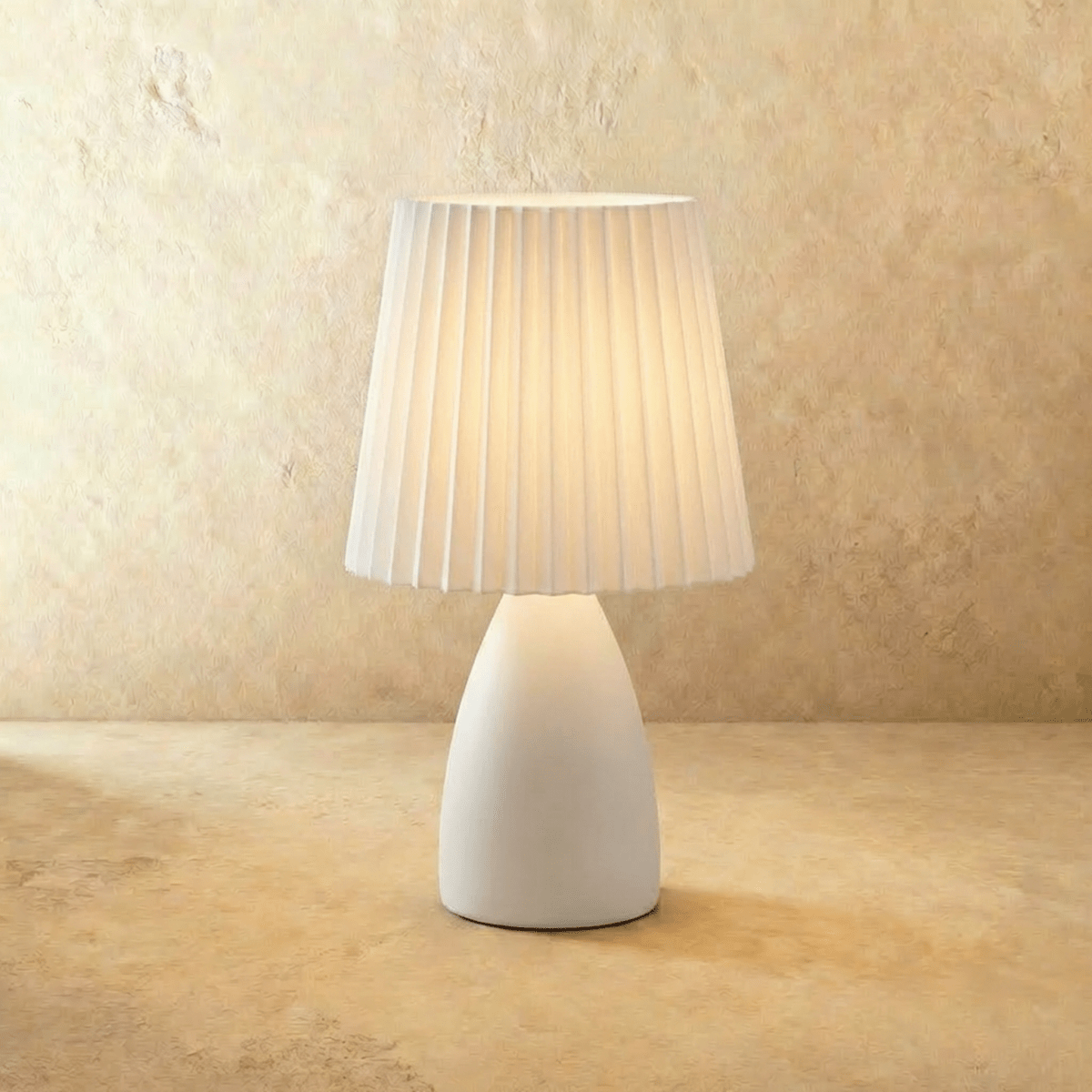 Residence Supply Apollo Table Lamp with a sleek modern design and a neutral-colored lampshade on a wooden side table.