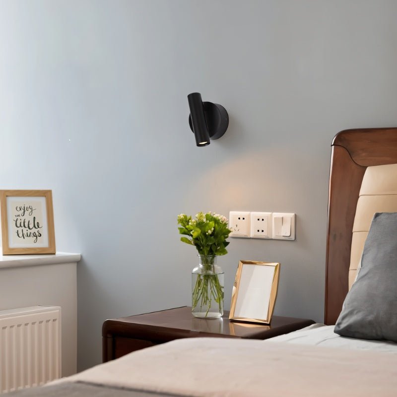 Black Residence Supply Asmra bedside reading lamp on a bedroom nightstand, with adjustable arm and modern design.