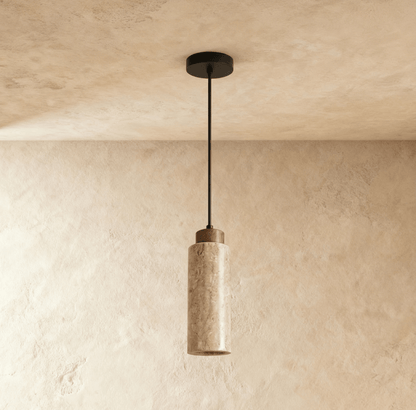 Aveno pendant light by Residence Supply hanging from ceiling with modern design and warm lighting in a contemporary interior.