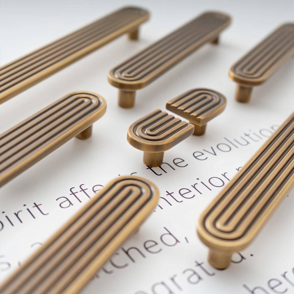 Brass Blaris knob and pull bar from Residence Supply, art deco style cabinet hardware, shown with detailed decorative design.