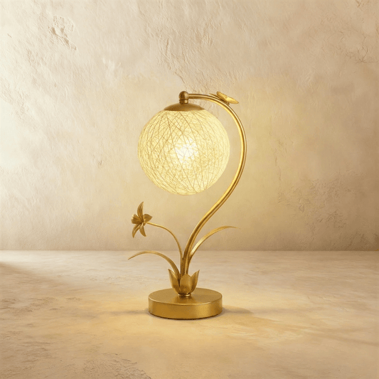 Residence Supply Bloom table lamp with a sleek, modern design featuring a ceramic base and fabric shade on a wooden table.