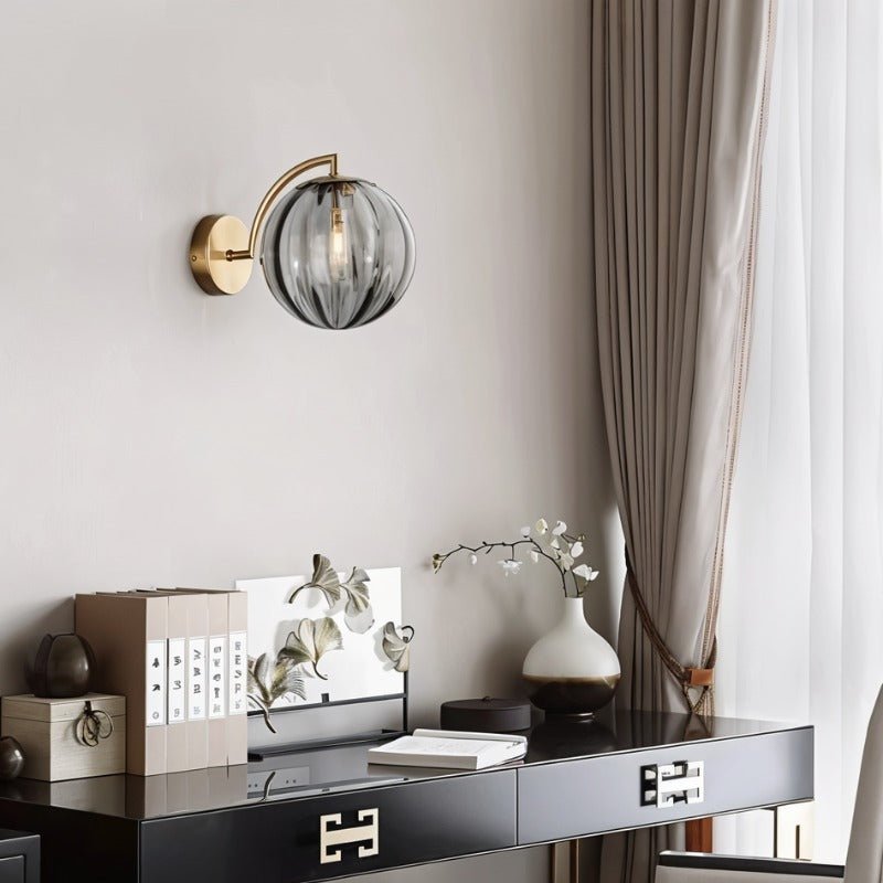 Carissa Wall Lamp by Residence Supply showing a modern wall-mounted light fixture with a sleek, curved design and warm finish.