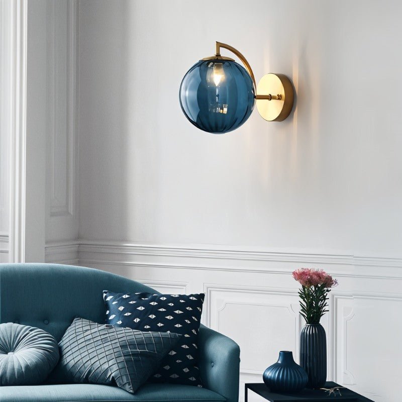 Carissa wall lamp by Residence Supply featuring a sleek, modern design with a curved metal arm and frosted glass shade.