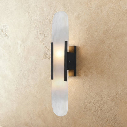 Cecelia Alabaster Wall Lamp by Residence Supply mounted on a wall with a smooth alabaster shade and modern design.