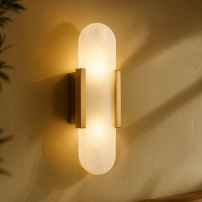 Cecelia Alabaster Wall Lamp by Residence Supply mounted on a wall with a warm glow, featuring a classic alabaster shade and elegant design.