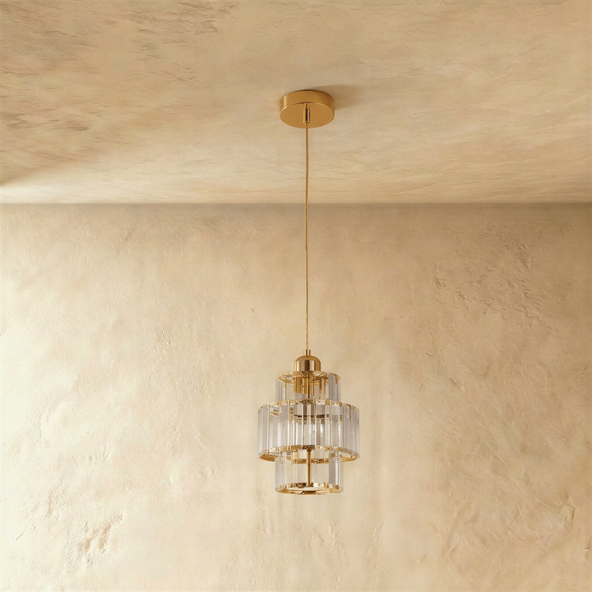 Residence Supply Charagh pendant light with a sleek, modern design and a metallic finish, hanging from a ceiling fixture.