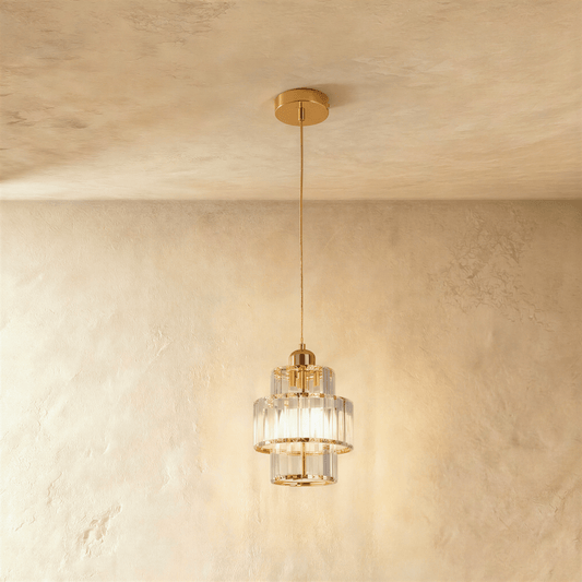 Charagh Pendant Light by Residence Supply hanging with a modern design, featuring a sleek metal frame and clear glass shade.