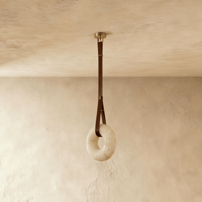 Cingeto Alabaster Pendant Light by Residence Supply hanging from ceiling with warm glow and sleek alabaster shade.