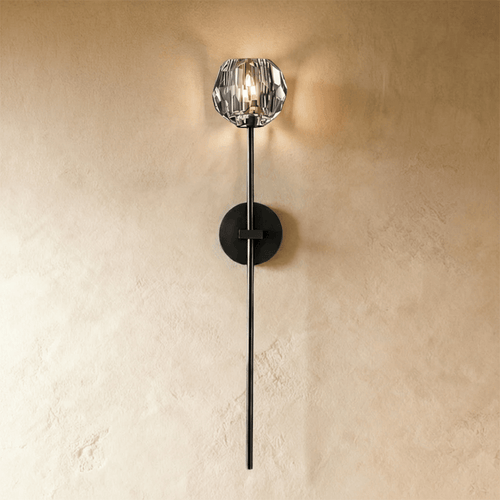 Cristo wall lamp by Residence Supply featuring a modern design with a sleek metal finish and a curved arm for stylish lighting.