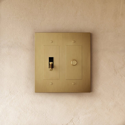 Custom brass light switch by Residence Supply with vintage design and toggle switch, showcasing detailed metal craftsmanship.