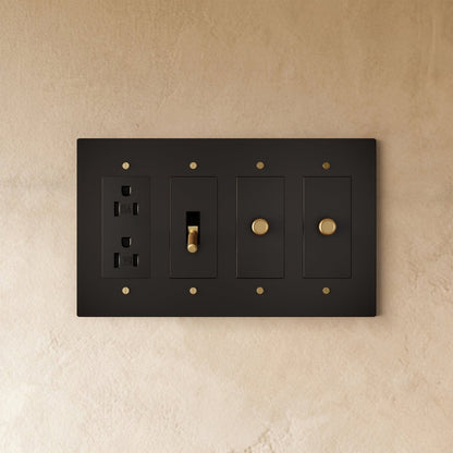 Custom brass light switch from Residence Supply with adjustable switch plates and vintage-style brass finish.