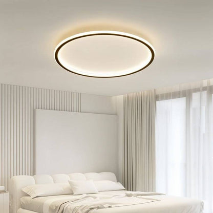 Modern Dayira ceiling light by Residence Supply featuring a sleek, circular metal design with a glass diffuser for ambient lighting.