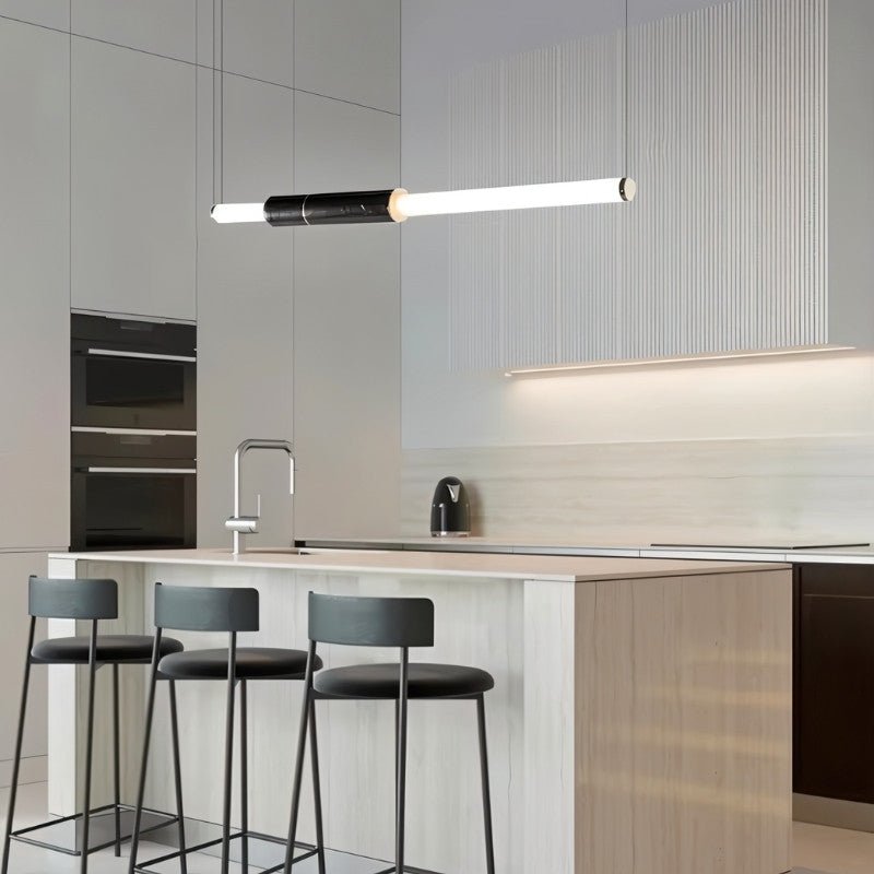 Modern Delia Pendant Light by Residence Supply hanging above a kitchen island with a sleek, contemporary design and warm lighting.