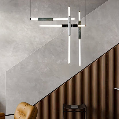 Modern Delia Pendant Light by Residence Supply hanging above a staircase, featuring sleek design and warm lighting.