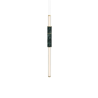 Modern vertical Delia Pendant Light by Residence Supply hanging from ceiling with sleek design and warm illumination.
