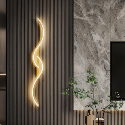 Residence Supply Denisse Wall Lamp with sleek modern design and warm lighting, mounted on a wall in a stylish interior setting.