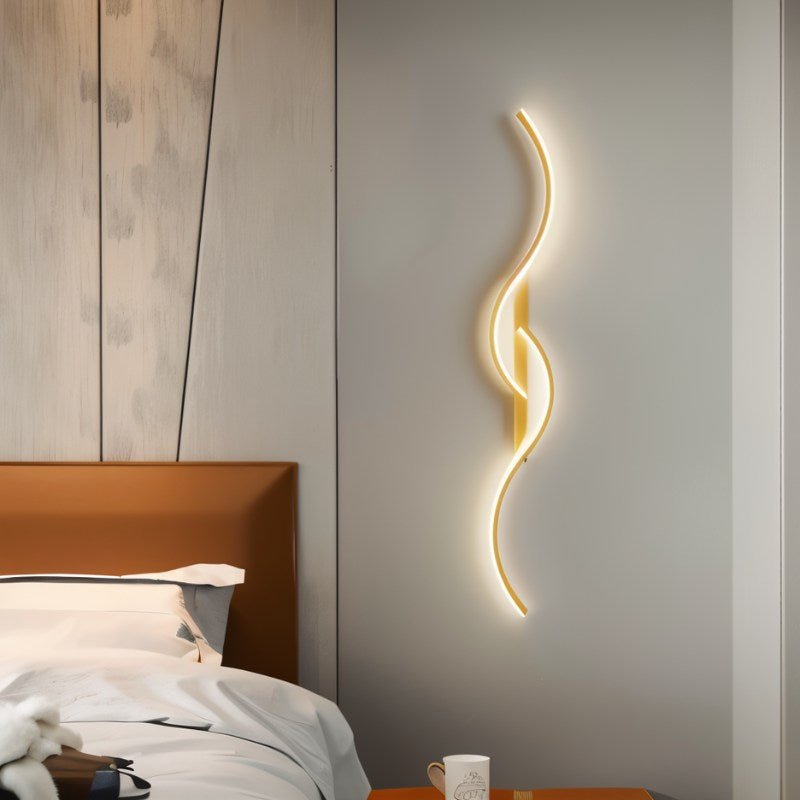 Denisse wall lamp by Residence Supply featuring a sleek, modern design with a curved metal arm and a cylindrical light shade.