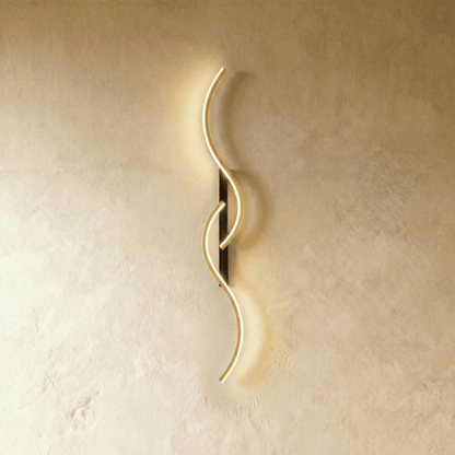 Modern Denisse wall lamp by Residence Supply featuring a sleek metal design and soft ambient lighting.