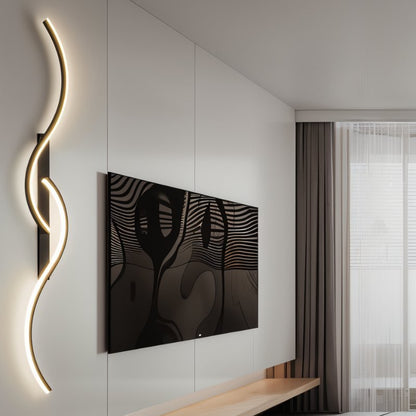 Denisse wall lamp by Residence Supply featuring a sleek, modern design with a curved metal arm and a cylindrical shade.