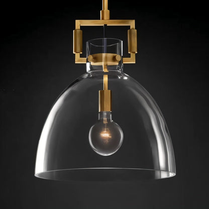 Modern Dennise Pendant Light by Residence Supply with a sleek metal finish and clear glass shade hanging from a ceiling mount.