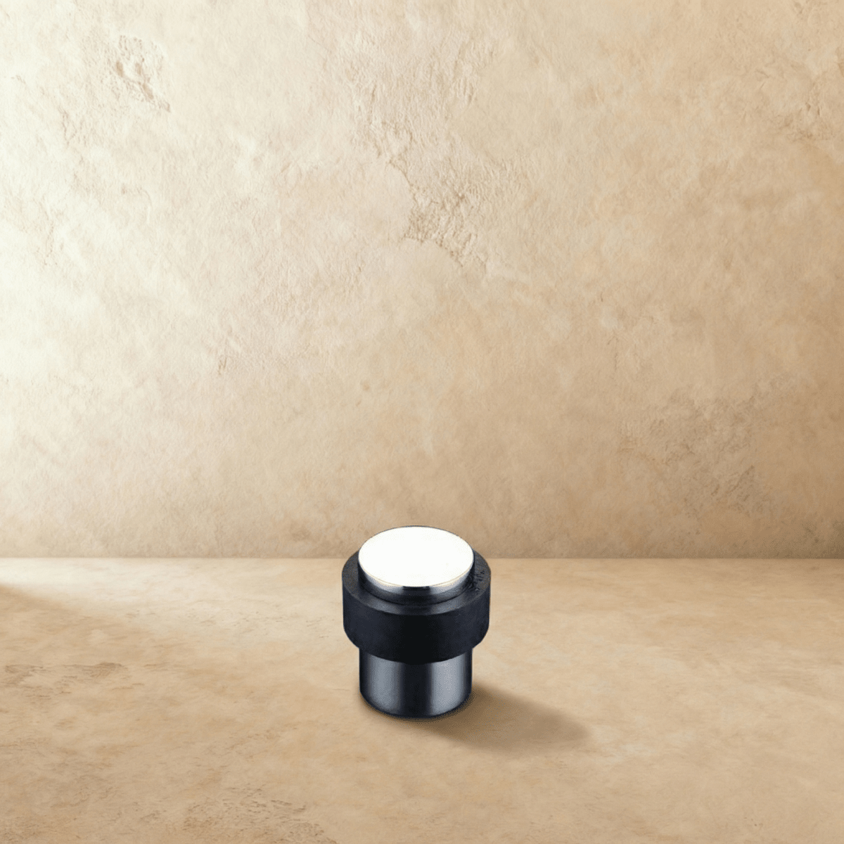 Residence Supply Desist Door Stop in metal with rubber tip, mounted on a door to prevent movement and protect walls.