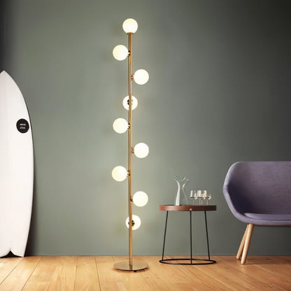 Residence Supply Domena Floor Lamp with sleek modern design and a tall, cylindrical white shade for living room lighting.