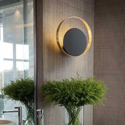 Residence Supply Eclipse Wall Lamp featuring a sleek, modern design with a circular, eclipse-inspired shape and soft lighting.