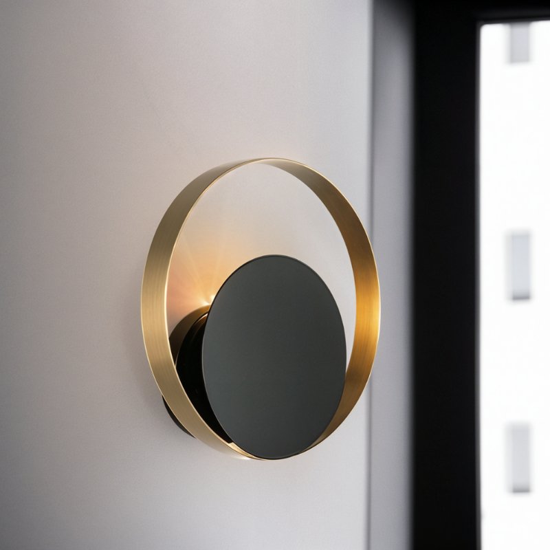Residence Supply Eclipse Wall Lamp with sleek black finish and modern design, mounted on a wall for ambient lighting.