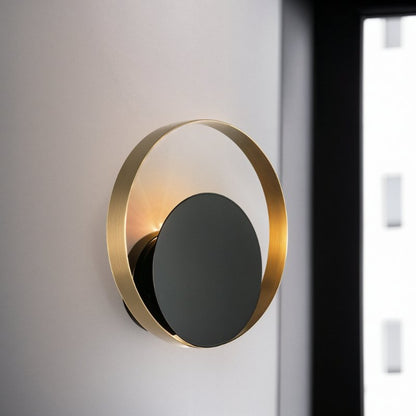 Residence Supply Eclipse Wall Lamp with sleek black finish and modern design, mounted on a wall for ambient lighting.