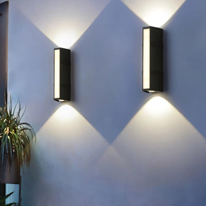 Outdoor wall lamp by Residence Supply with a sleek, modern design in black finish, mounted on a brick wall.
