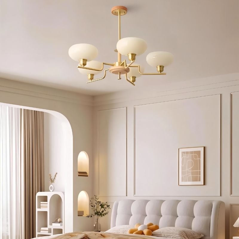 Eronix brass and wood chandelier with glass shades hanging in a bedroom setting, stylish lighting fixture by Residence Supply