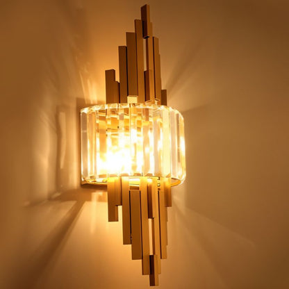 Eudora Wall Lamp by Residence Supply, modern design with sleek metal finish, mounted on a wall with warm lighting.