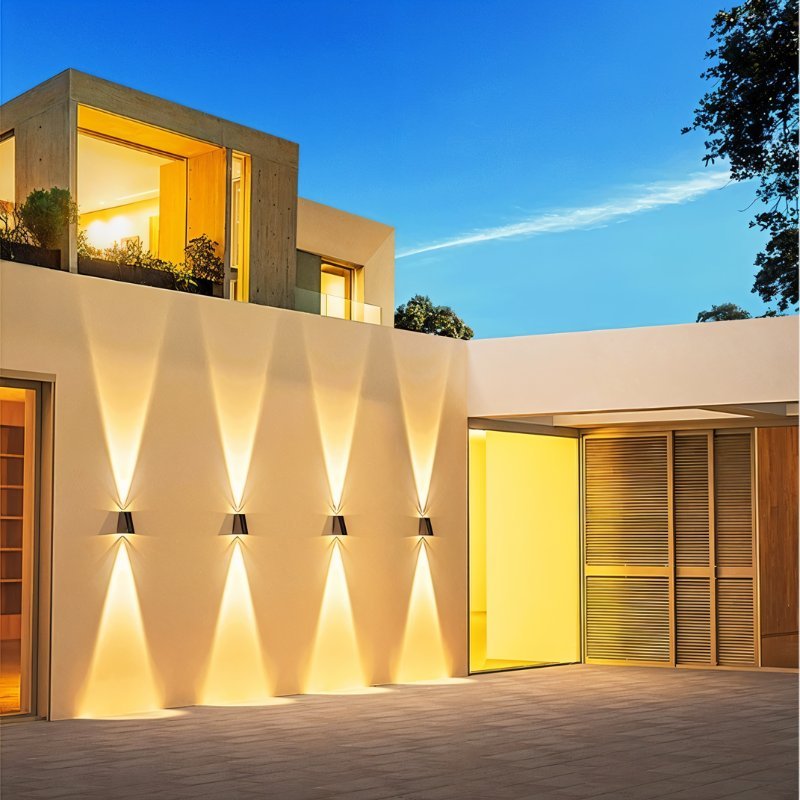 Exterior wall lamp by Residence Supply with a modern design, mounted on outdoor wall, featuring a sleek metal finish and glass shade.