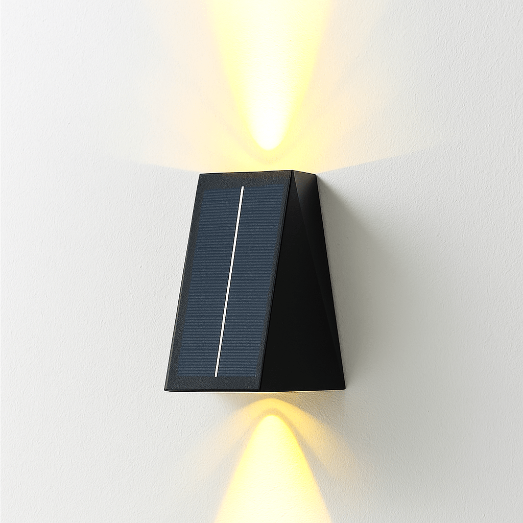 Residence Supply Exterius outdoor wall lamp illuminating a textured exterior wall with a modern black finish and warm lighting.